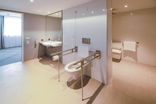 a bathroom with a toilet and a sink at Premier Inn Karlsruhe City Am Wasserturm in Karlsruhe