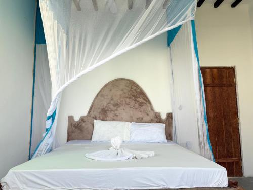 Ένα ή περισσότερα κρεβάτια σε δωμάτιο στο Zanzi coconut house