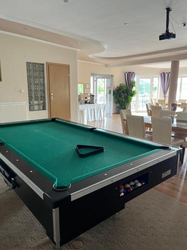 a pool table in a living room with afits at Eva in Mrągowo