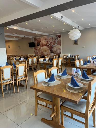 a dining room with wooden tables and chairs at Eva in Mrągowo