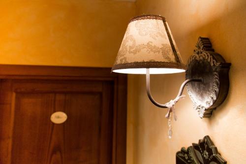a bird lamp hanging on a wall next to a door at Hotel Relais Pian delle Starze in Marina di Camerota