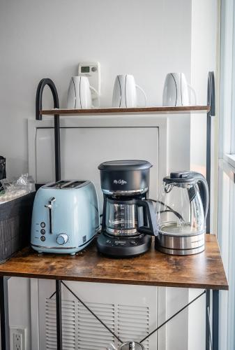 a shelf with a toaster and a blender on it at 1 Bedroom plus Den Condo Garden View Fort York Downtown Toronto in Toronto