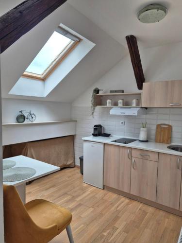 a kitchen with a skylight in the ceiling of a room at City Nest Apartments NS in Novi Sad