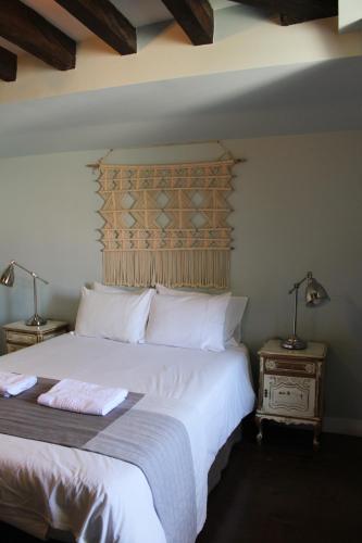 a bedroom with a large white bed and two lamps at Rossio Hostel in Lisbon