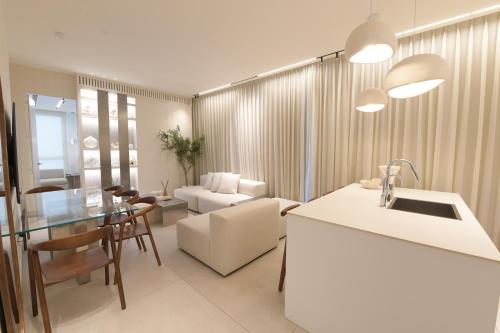 a kitchen and living room with a table and a couch at Omega Pent House in Eilat