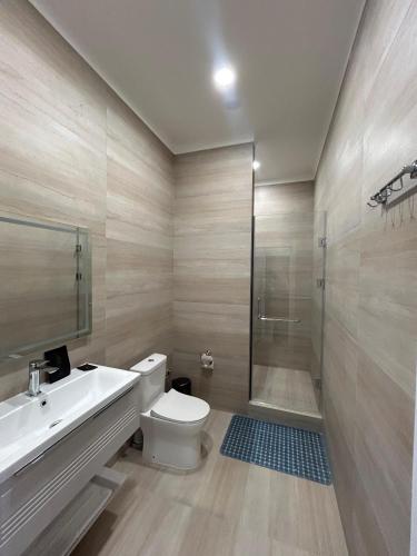 a bathroom with a sink and a toilet and a shower at Boutique Hotel "White HiLL" in Aktau