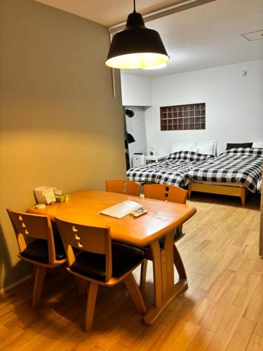 a room with a table and chairs and a bed at 8108 yadoya in Ogori