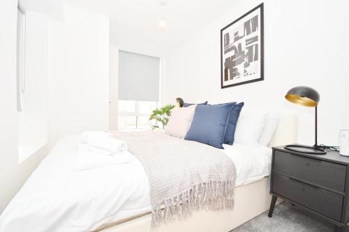 a white bedroom with a bed and a dresser at Modern & Bright 1BED Flat in Central Sheffield in Midland