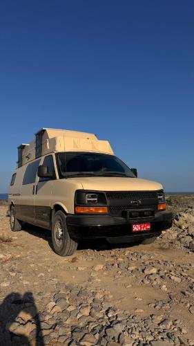 a camper van parked on a rocky road at Motorhome RV Oman in Muscat