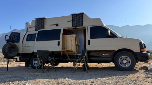 a white camper van parked in the desert at Motorhome RV Oman in Muscat