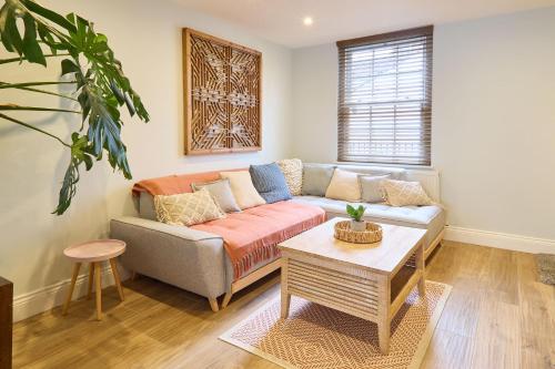 a living room with a couch and a table at Host & Stay - Aurora in Deal