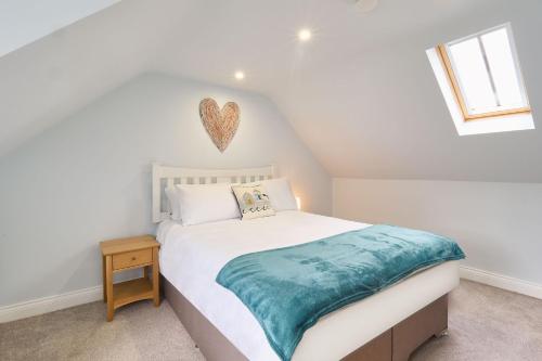 a bedroom with a bed with a heart on the wall at Host & Stay - Aurora in Deal