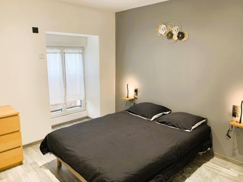 a bedroom with a large bed and a window at Le Gîte du Plessis Montanel à 25 mn du Mont Saint-Michel in Montanel