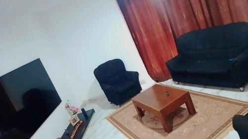 a living room with a chair and a table at Sal Blue Apartment in Santa Maria