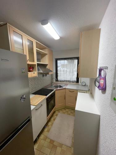 a small kitchen with a refrigerator and a sink at Unterkirnach in Unterkirnach