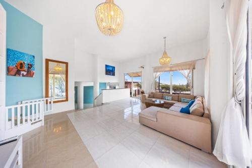 a living room with a couch and a table at Beautiful 5BR Villa *Zen*Nature*Views*BBQ*BathTub* in Noord