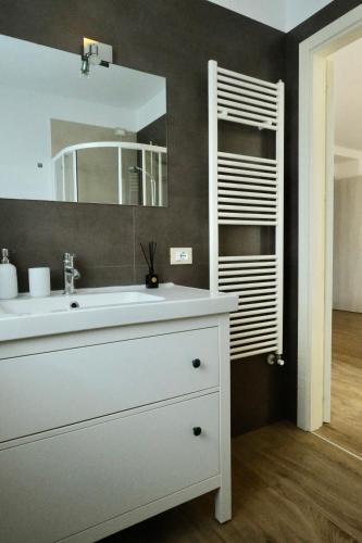 a bathroom with a white sink and a mirror at Ca' Marì Torricelle Bed&Breakfast in Verona