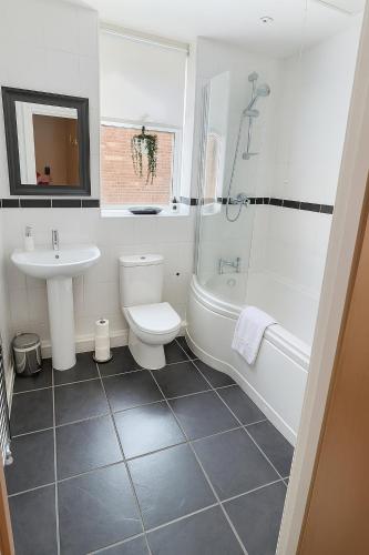 a bathroom with a sink and a tub and a toilet at Lady Peckett's Yard in York