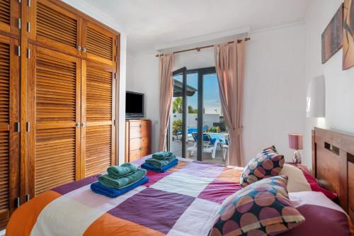 a bedroom with a bed with pillows on it at Villa Tania in Playa Blanca