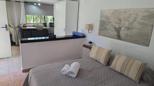 a bedroom with a bed with two towels on it at Finca Feliciano in Novo Sancti Petri