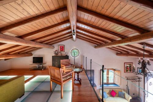 a living room with wooden ceilings and wooden beams at Villa With Pool And Vineyards Among Etna Vineyards in Santa Maria di Licodia