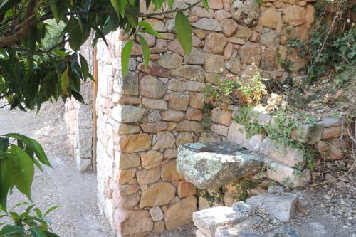 a stone wall with a stone bowl on it at L'Ortu Di Pisettu -1 in Conca