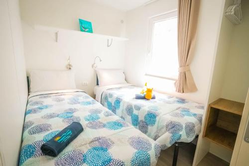 Postel nebo postele na pokoji v ubytování Happy Camp Mobile Homes in Torre Rinalda