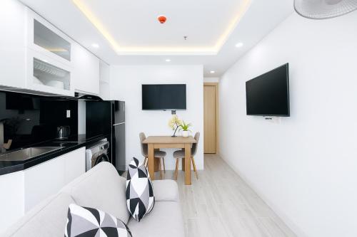 a living room with a couch and a table at Louis Luxury Apartment & Hotel in Da Nang