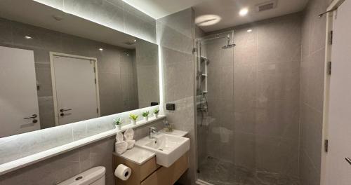 a bathroom with a sink and a mirror at The one ratchaphruek in Ban Nong Bua