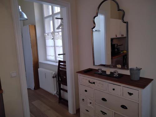 a bathroom with a dresser with a mirror on it at ciao-aschau Haus Burg Studio-Apartment101 in Aschau im Chiemgau
