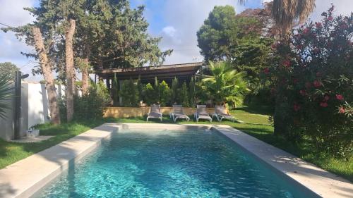 a swimming pool in the backyard of a house at Finca Feliciano in Novo Sancti Petri