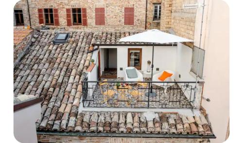 a view of a roof with a table and an umbrella at CASA GAH in Ripatransone