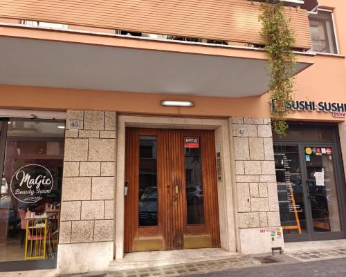 a store with wooden doors on a building at Lilla Eco House - Vaticano in Rome