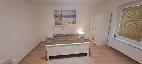 a small bedroom with a bed and a window at Ubytování Lipová in Jihlava
