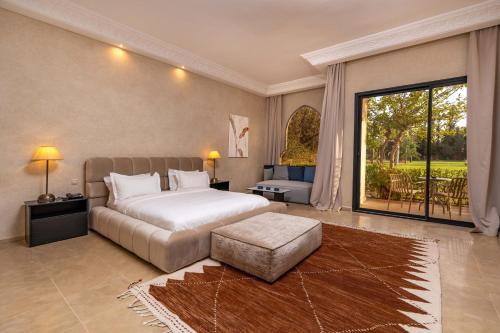 a bedroom with a bed and a large window at Palais Nouhass in Marrakech
