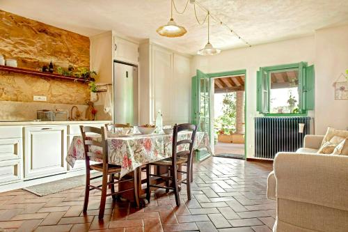 a kitchen and dining room with a table and chairs at 16Th Century Farmhouse Between The Tuscan Hills in Brancorsi