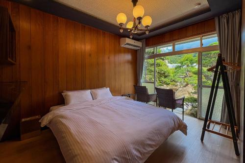 a bedroom with a bed and a large window at 蒼々さぬき志度 SOUSOU Sanuki Shido in Sanuki