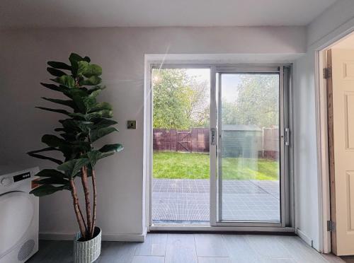 Una puerta abierta a un patio con una planta en maceta. en Haven House in Northampton, en Great Billing