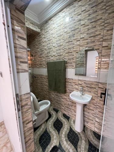 a bathroom with a sink and a toilet at 2 Chambres Élégantes Confort Moderne in Santeo