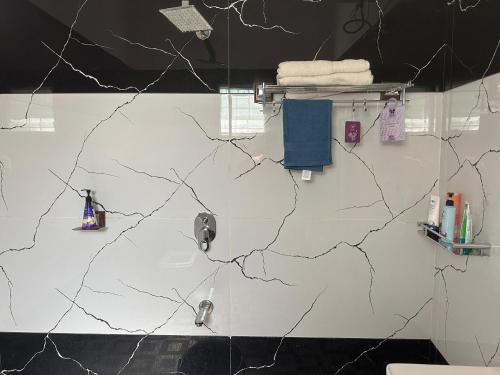 a bathroom with two sinks and a white wall at Tranquil Farmstay by Vanaja Farms in Rāmanagaram