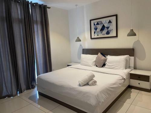 a bedroom with a bed with a towel on it at Embassy Onebedroom by Unique Abodes in Accra