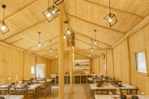 a dining room with tables and chairs and lights at Heyan Cedar Woods Nainital, 5 Mins walk from Mall Road in Nainital