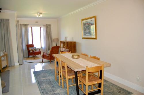 a dining room with a table and chairs at Castleton Self-Catering Accommodation in Plettenberg Bay