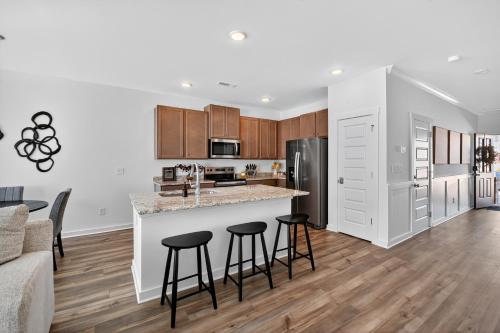 an open kitchen and living room with a counter and stools at Discovery Haven townhouse in Monrovia
