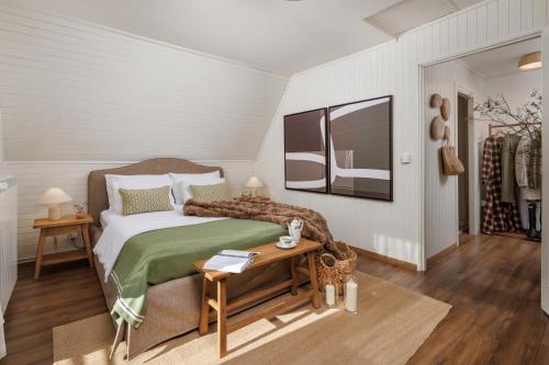 a bedroom with a bed and a table and a mirror at Hillside Lodge, Boutique & Spa in Lič