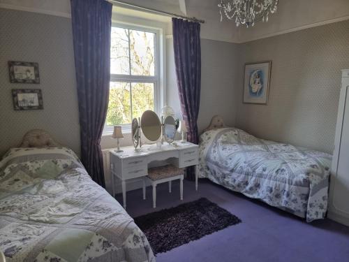 En eller flere senge i et værelse på Ashleigh House