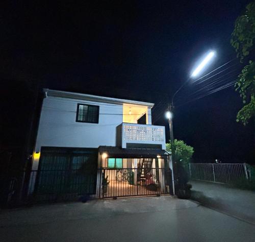 a building with a sign in front of it at night at D sleep Home Chiangmai in Chiang Mai