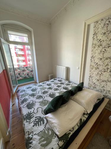a bedroom with a bed in a room with a window at Cozy room with private balcony, center berlin in Berlin