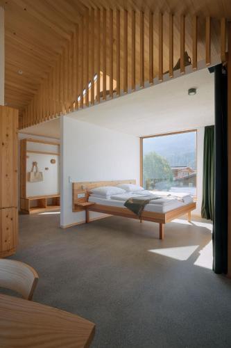 a bedroom with a bed and a large window at Haus Aerli in Ehrwald