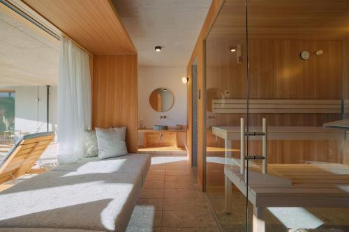 a bedroom with a bed and a table and a mirror at Haus Aerli in Ehrwald